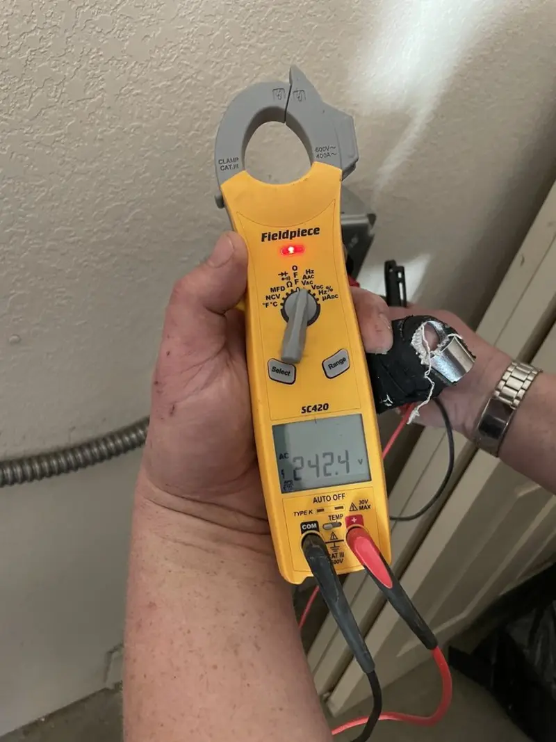 Voltage testing with clamp meter during Electrical Installation Services in Oneida